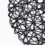 Close-up of black woven placemat texture on white background