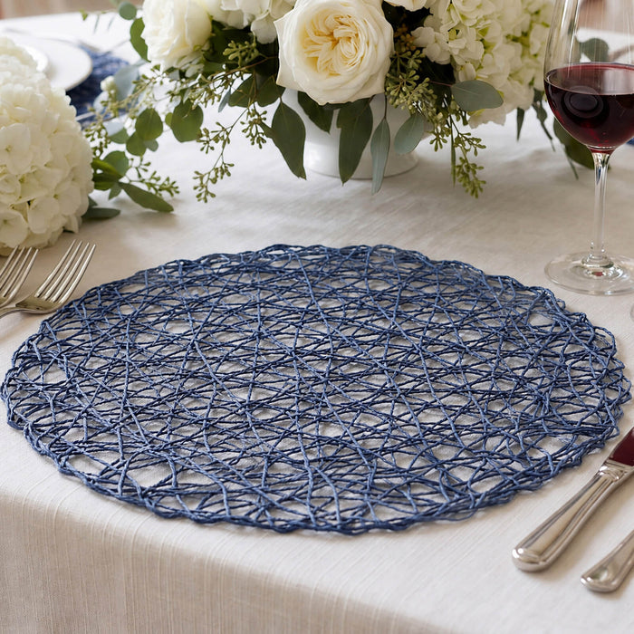 Blue woven placemat on elegant dining table with white floral centerpiece