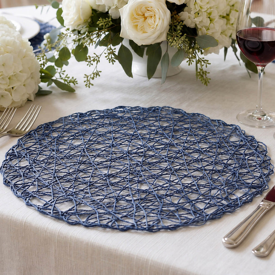 Blue woven placemat on elegant dining table with white floral centerpiece