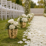 Wedding aisle with white rose flower arrangements and petal walkway outdoors