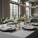 Elegant green glassware set on a beautifully arranged dining table.