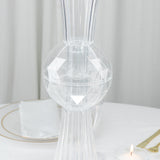Elegant crystal candle holder with geometric design on a table setting.