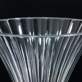 Clear ribbed glass vase with a flared top.