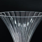 Clear ribbed glass vase with a flared top.
