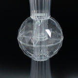 Clear geometric glass vase with a textured surface.