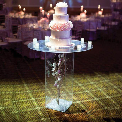Acrylic box with a gold vase and white flowers
