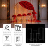 5-piece clear acrylic pedestal riser set displaying red floral centerpieces with warm fairy light...