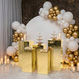 Elegant dessert display with gold accents and balloon decoration.