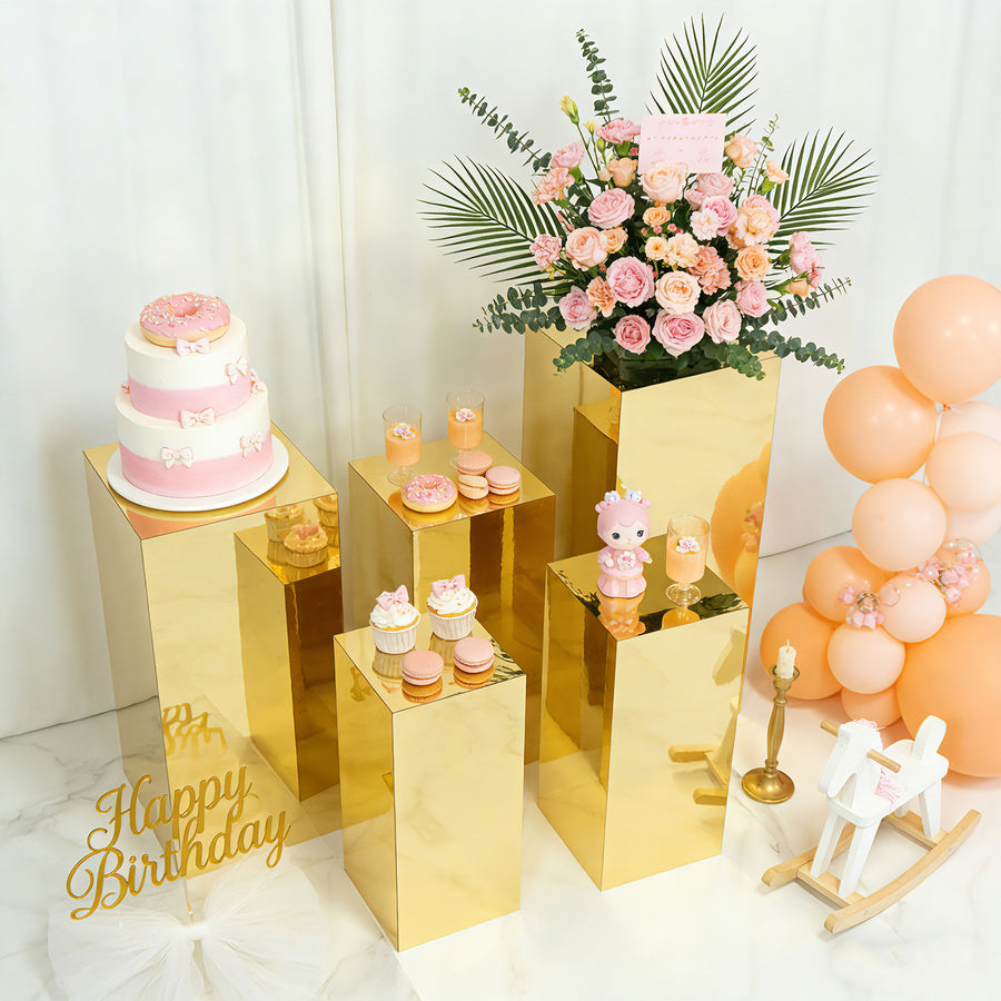 Birthday party setup with cake, flowers, and decorative treats.