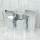 Set of mirrored display pedestals in various heights and shapes against a white backdrop.