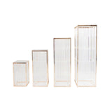 Set of four glass storage boxes with gold accents on a white background. #whtbkgd