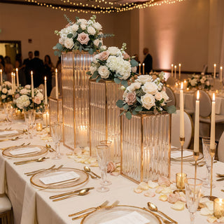 Elegant wedding table setting with floral centerpieces and candlelight ambiance.