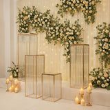 Elegant gold display stands with floral backdrop and soft lighting.