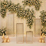 Elegant glass display pedestals adorned with floral backdrop and soft lighting.