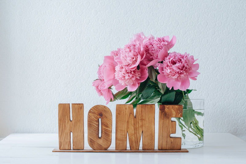 HOME letters with pink flowers in a vase