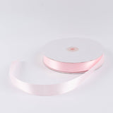 Light pink satin ribbon roll on white background