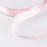 Pastel pink satin ribbon on white background