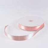 Pink satin ribbon roll on white background