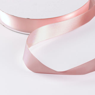 Pink satin ribbon on white background