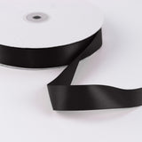 Black satin ribbon roll on white background, decorative craft ribbon
