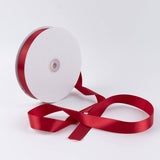 Red satin ribbon roll on white background