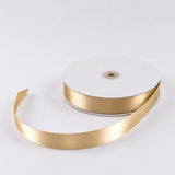 Gold satin ribbon roll on white background