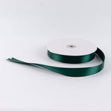 Dark green satin ribbon roll on white background