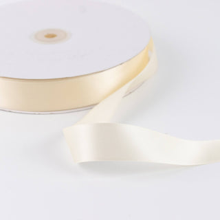 Cream satin ribbon roll on white background