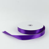 Purple satin ribbon spool on white background