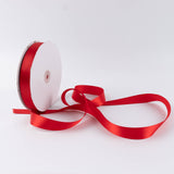 Red satin ribbon spool on white background