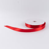 Red satin ribbon roll on white background
