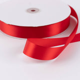 Red satin ribbon roll on white background