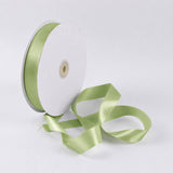 Light green satin ribbon spool on white background