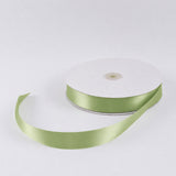 Green satin ribbon spool on white background