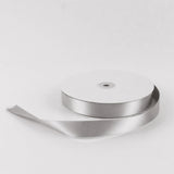 Silver satin ribbon spool on white background