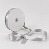 Silver satin ribbon spool on white background