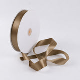 Gold satin ribbon spool on white background
