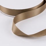Beige satin ribbon on white background