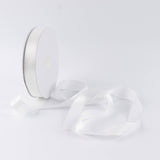 White satin ribbon spool on a minimalist white background