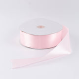 Pink satin ribbon roll on white background