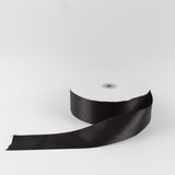 Black satin ribbon roll on white background