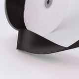 Close-up of black and white leather bag with gold ring detail