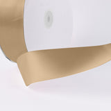 Beige satin ribbon close-up on white background