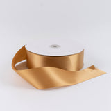 Gold satin ribbon roll on white background
