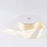 Ivory satin ribbon spool on white background