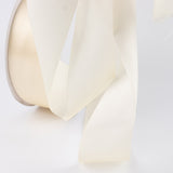 Cream satin ribbon bow on a white background