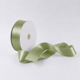 Light green satin ribbon spool on white background