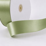 Light green satin ribbon spool with wide decorative ribbon close-up