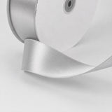 Silver satin ribbon on white gift box with hole detail