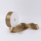 Gold satin ribbon spool on white background, decorative gift ribbon roll